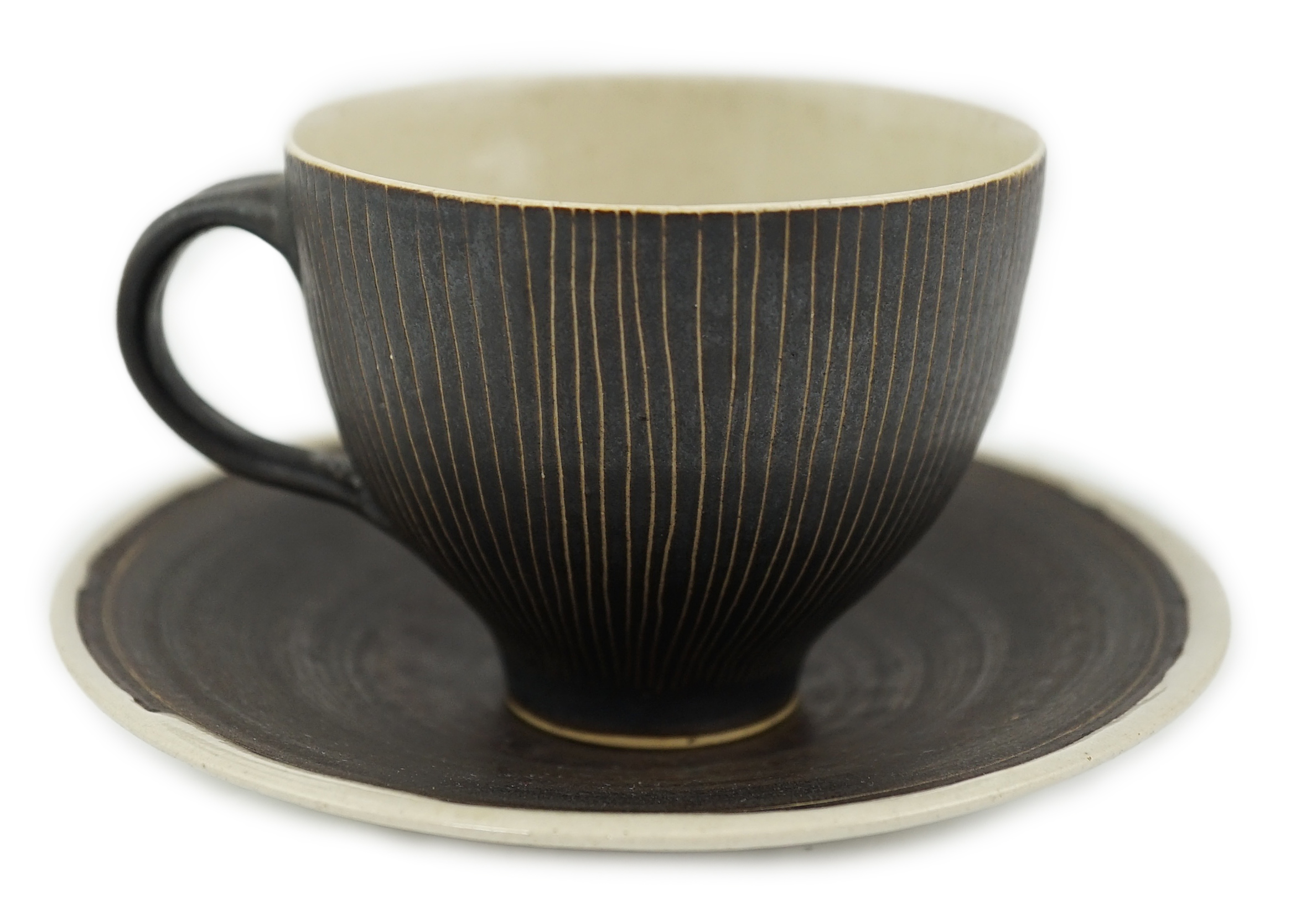 Dame Lucie Rie D.B.E. (1902-1995), a manganese glazed coffee cup and saucer